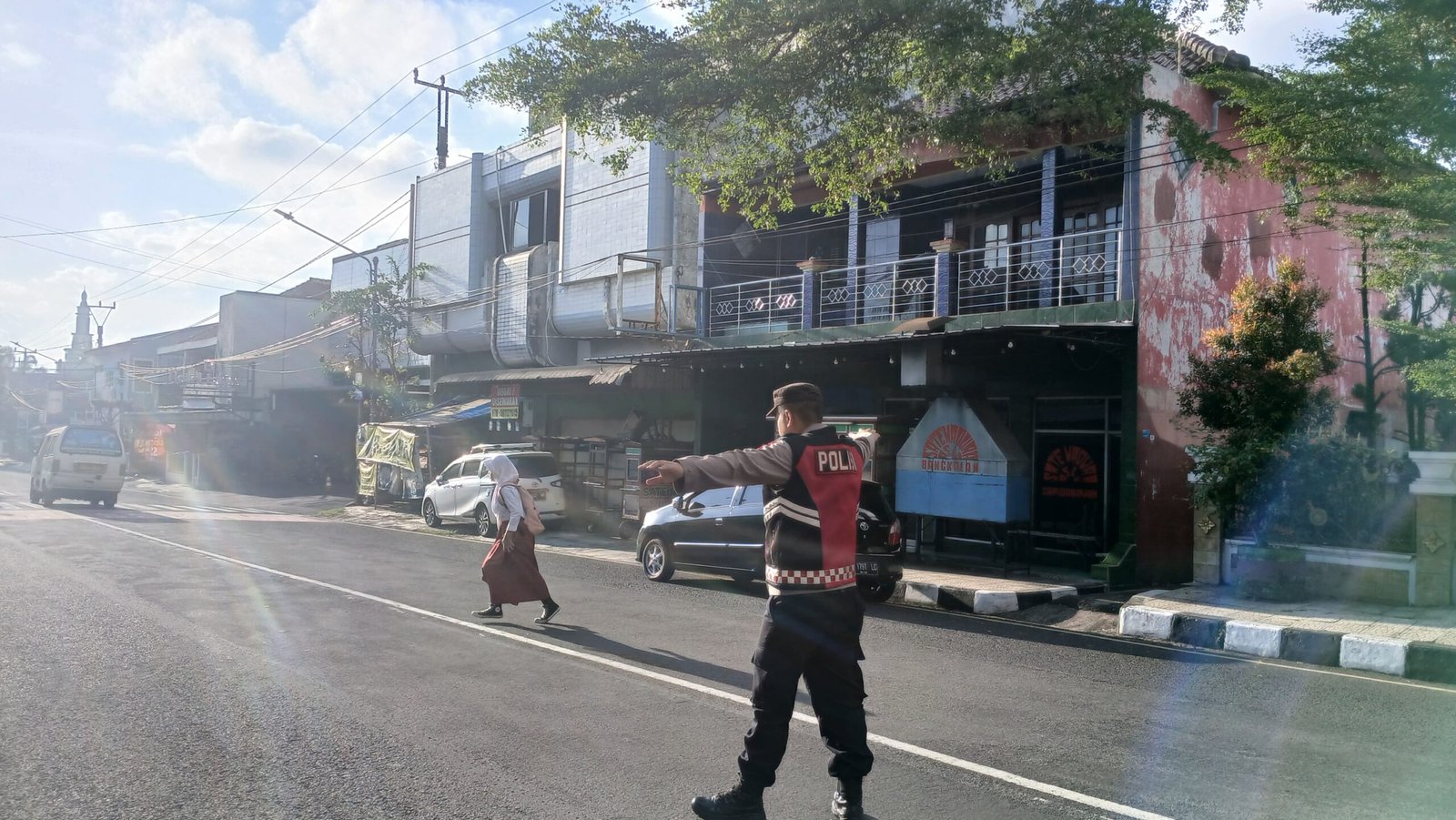 Pelayanan Masyarakat Kapolsek Ciamis Turun Bantu Anak Menyebrang di Area SDN 3 Ciamis